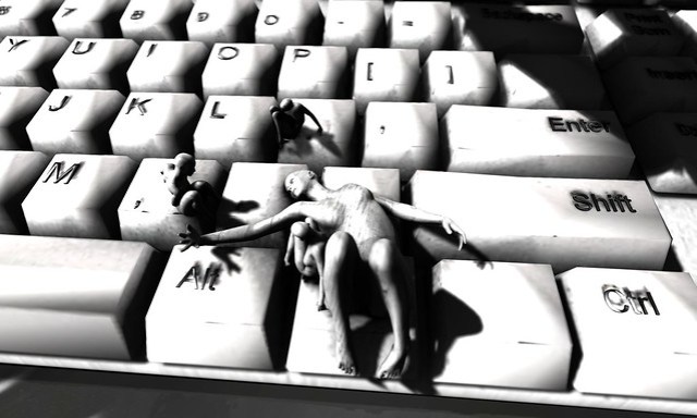 figures laying on a giant computer keyboard in black and white, very cool